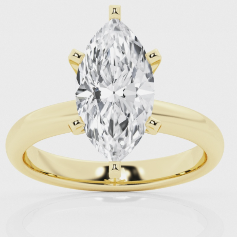 14 Karat Yellow Gold Diamond Solitaire Ring  Four Prong Set In A White Gold Center Is One Marquise Cut Diamond Weighing .58 Carat And Graded SI1 L.